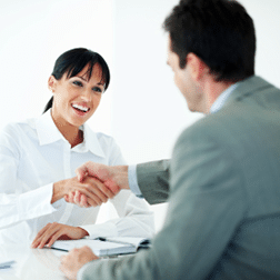 Business woman and man shaking hands.