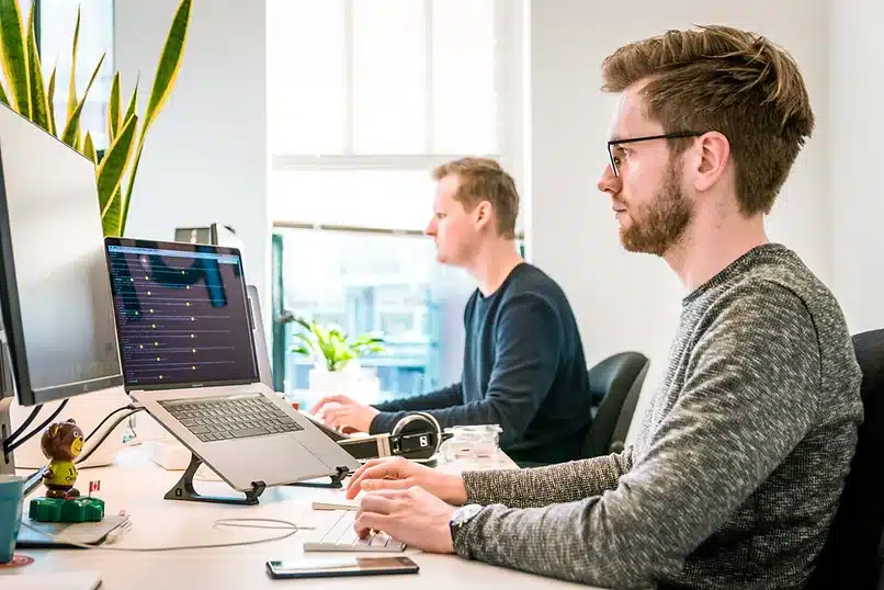 Man typing on computer at desk