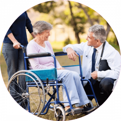 Doctor kneeling, talking to wheelchair bound senior